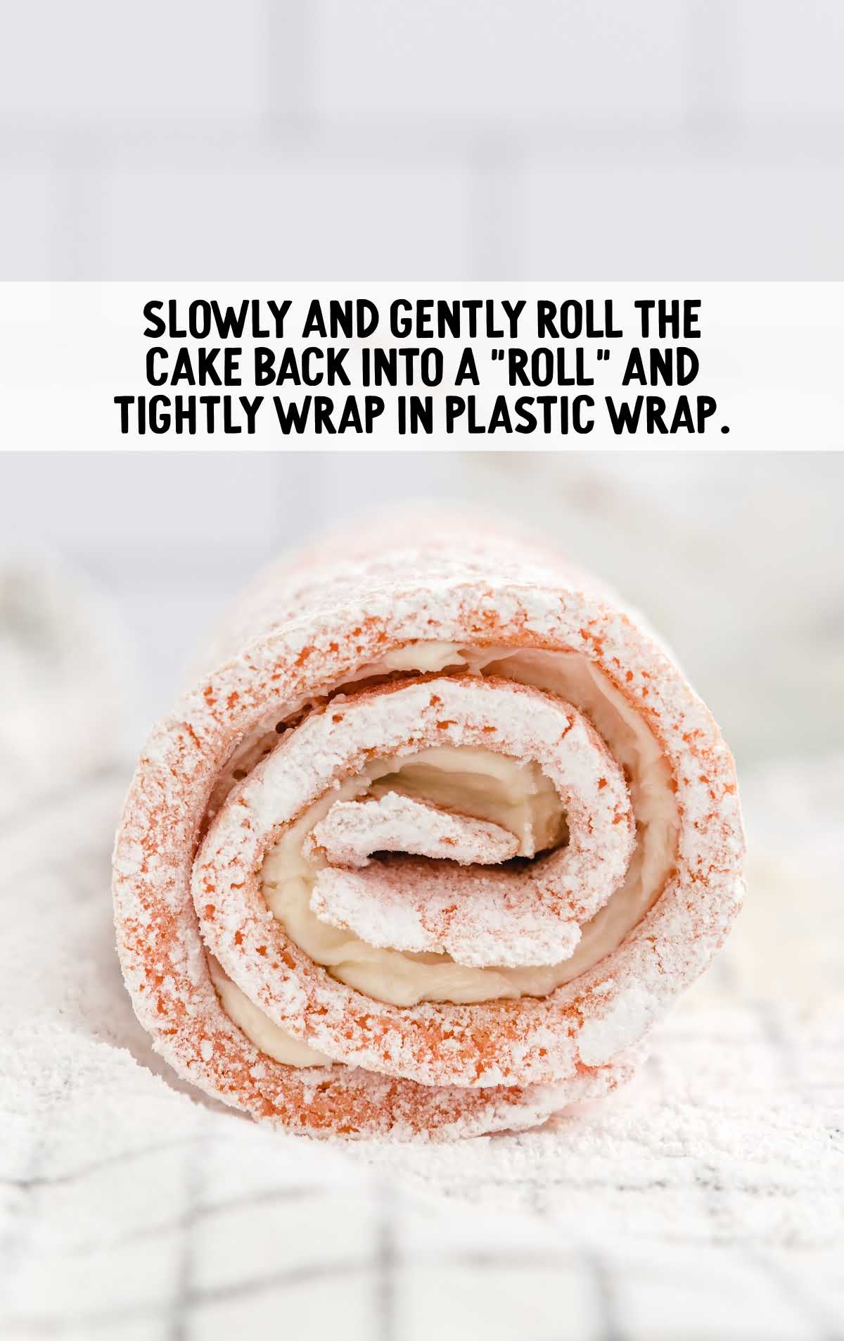 cake rolled up and wrapped in plastic wrap