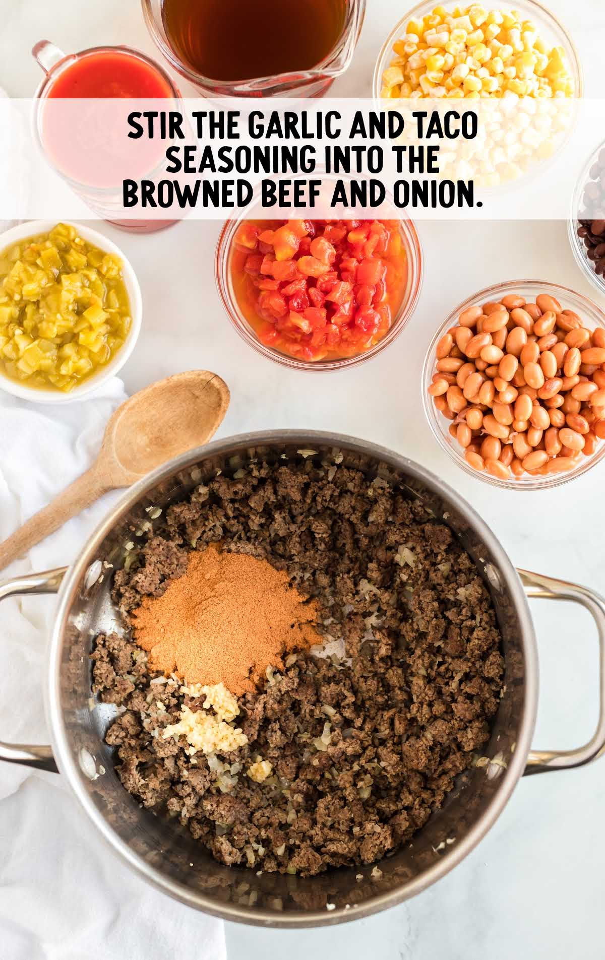 garlic and taco seasoning added to the pot of ground beef