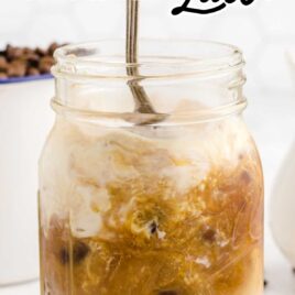 Vanilla Latte in a glass cup being stir with a spoon