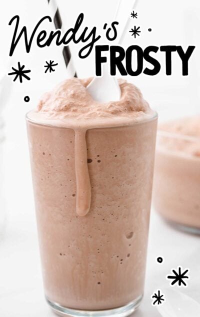 close up shot of homemade Wendy's frosty in a glass cup with a spoon and straw on top