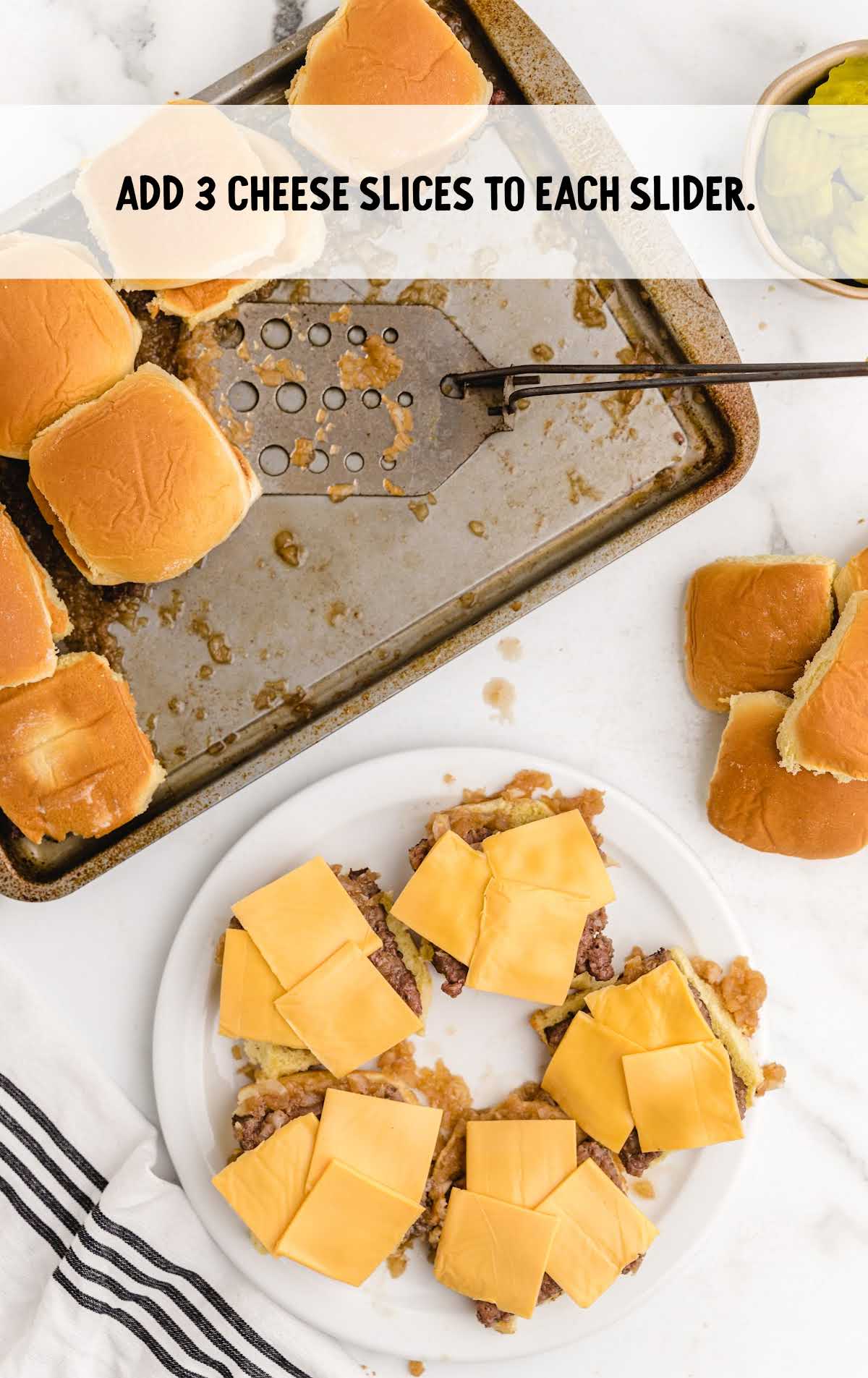 each slider topped with pieces of cheese