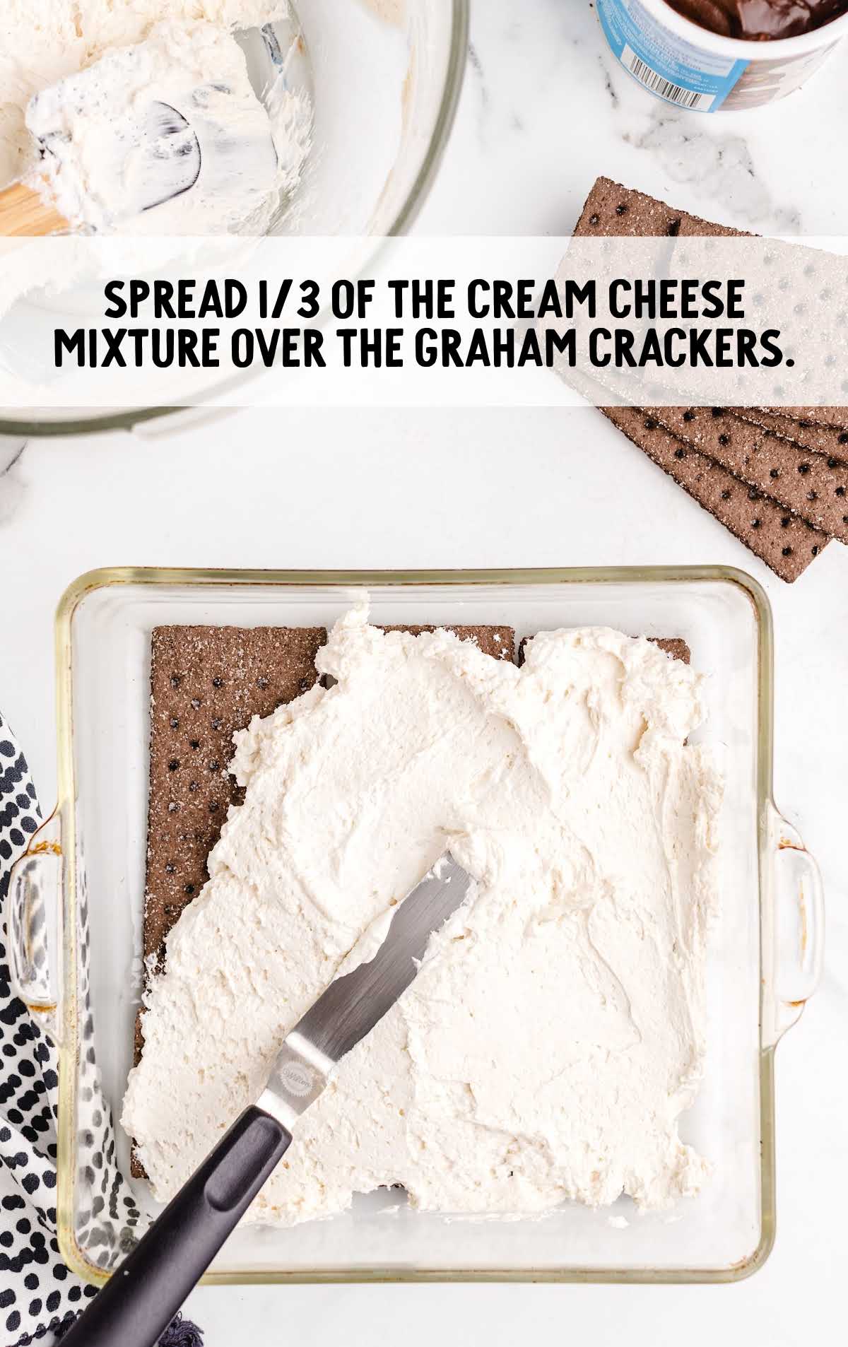cream cheese mixture spread on top of the graham cracker in the baking dish
