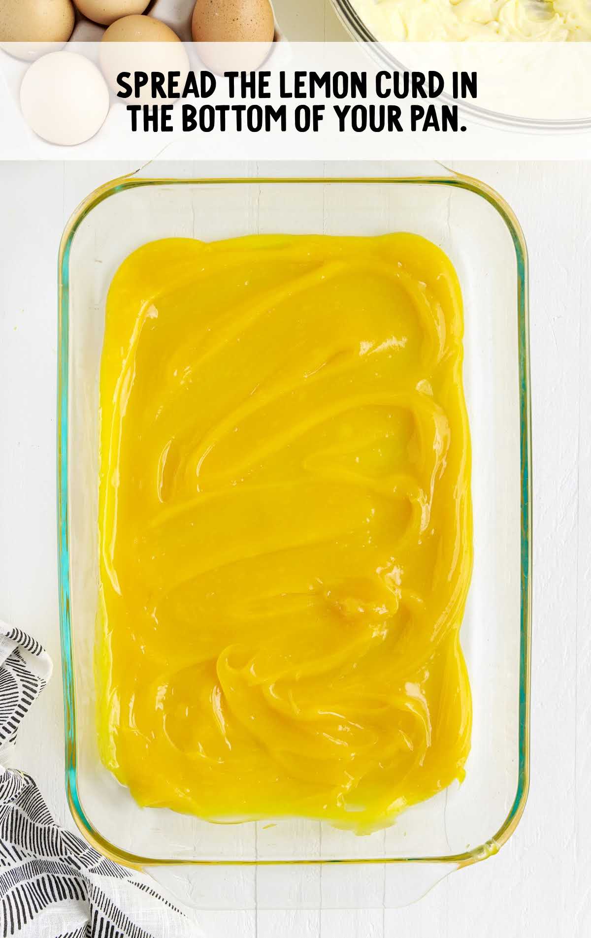 lemon curd spread at the bottom of the pan