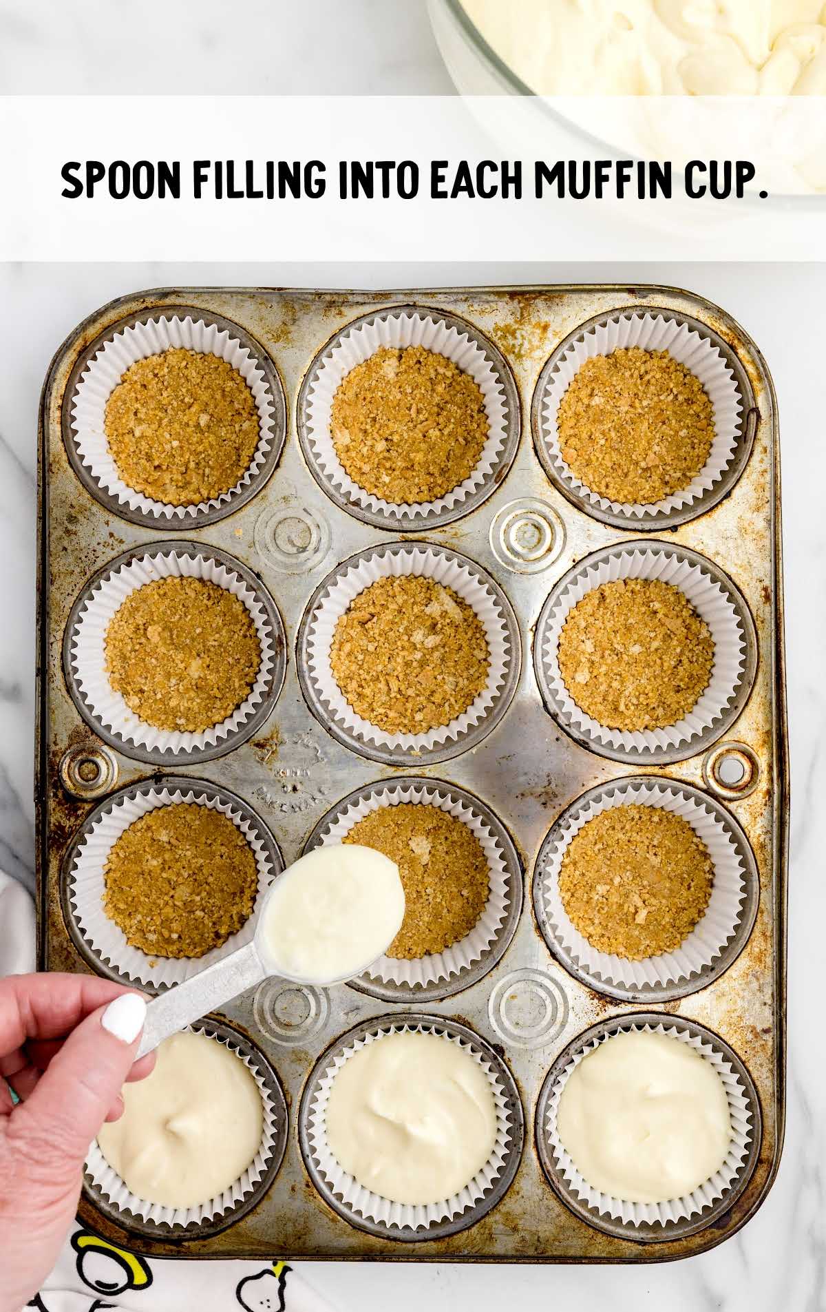 cheesecake mixture placed on top of the graham cracker crumbs