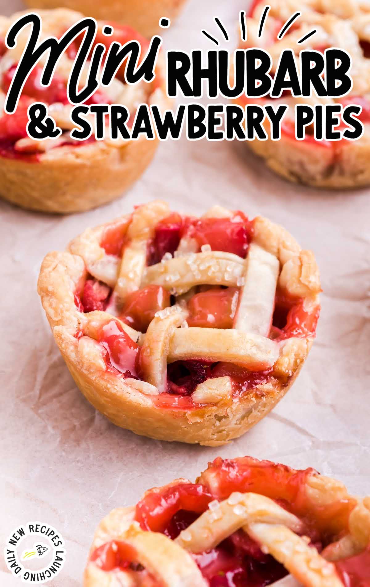 Mini Rhubarb and Strawberry Pies on a parchment paper