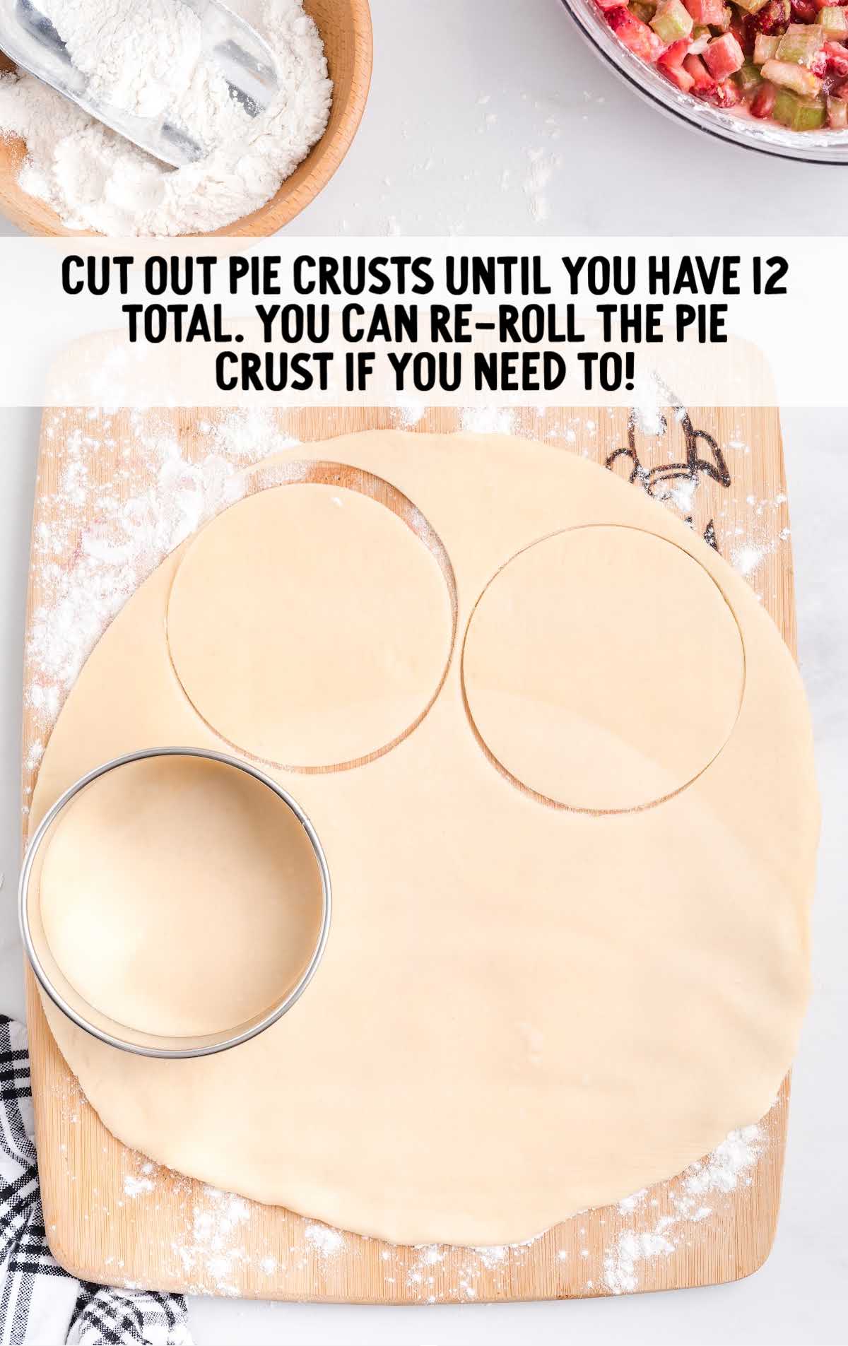 circles being cut out of the pie crust on a cutting board