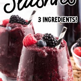 Red wine slushies topped with mixed berries on a glass cup