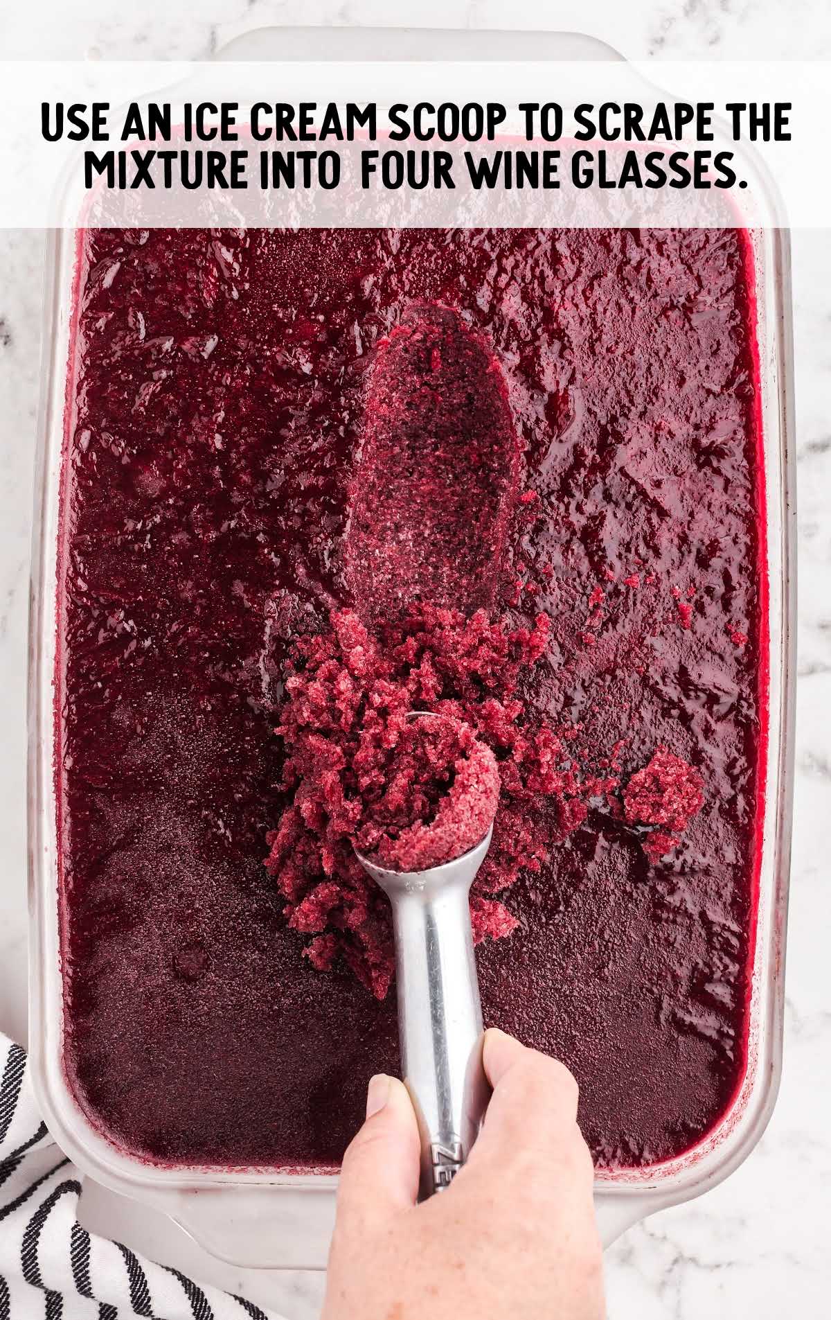 red wine slushies mixture being scooped out of baking dish