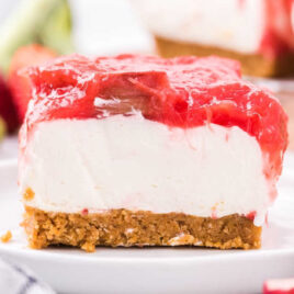 close up shot of a slice of Strawberry Rhubarb Cheesecake on a plate