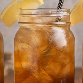 Mason jar of Texas Tea with lemon wedge and straw, labeled “Best Vintage Texas Tea for Sipping All Summer.”