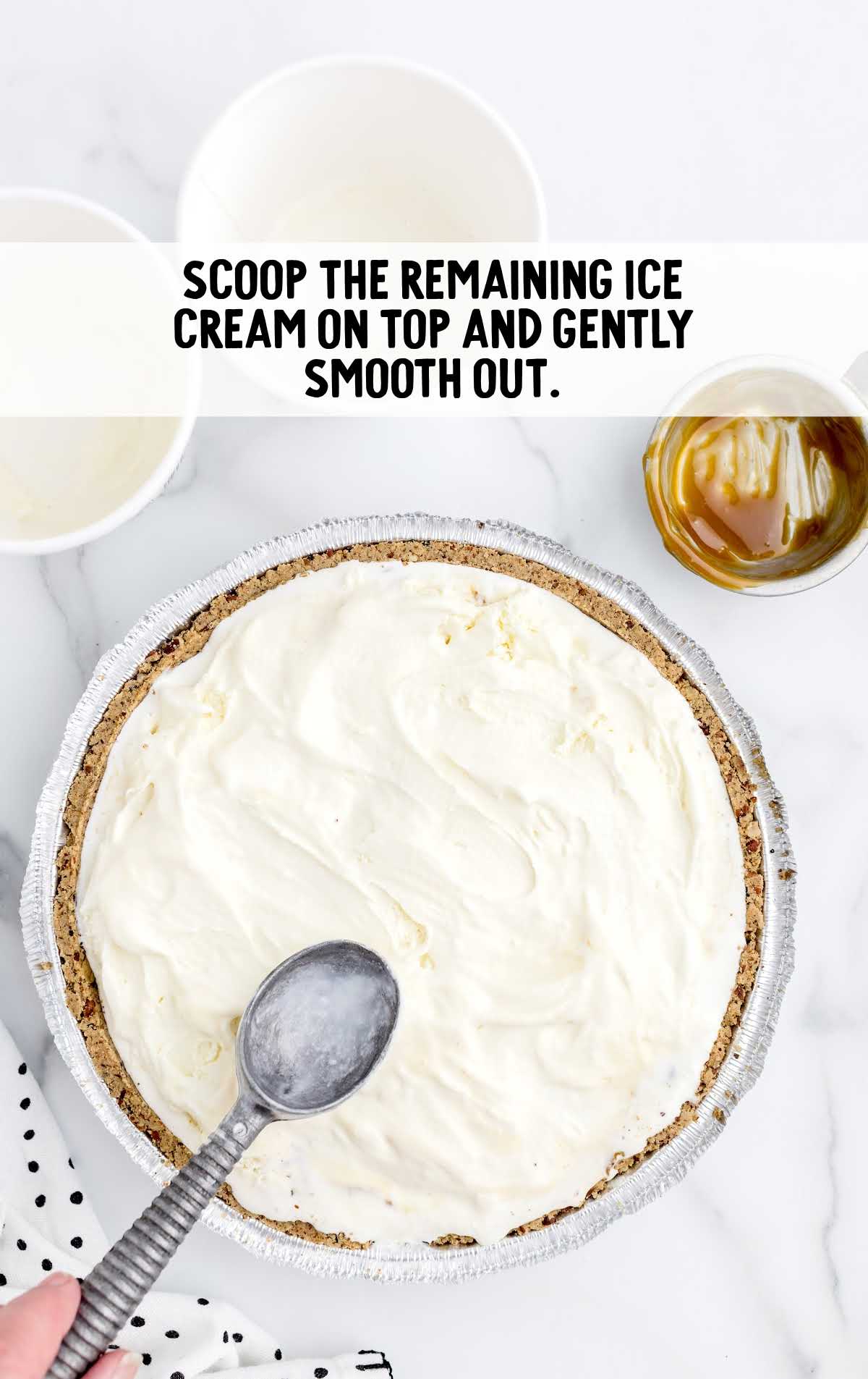 ice cream on top of the pie with an ice cream scooper