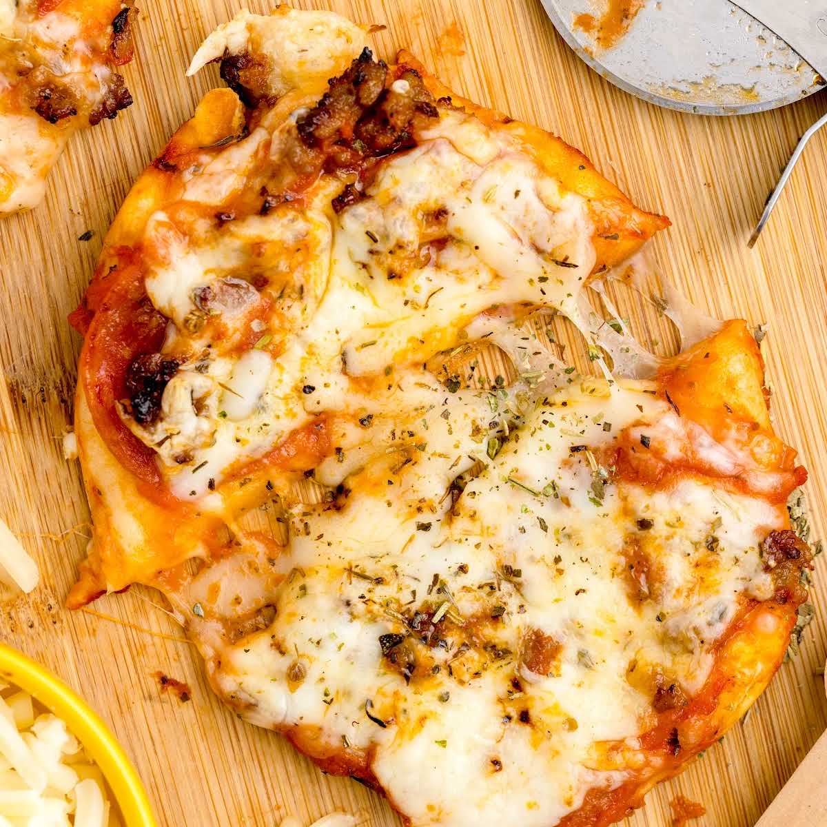 slice of Air Fryer Pizzas on wooden board