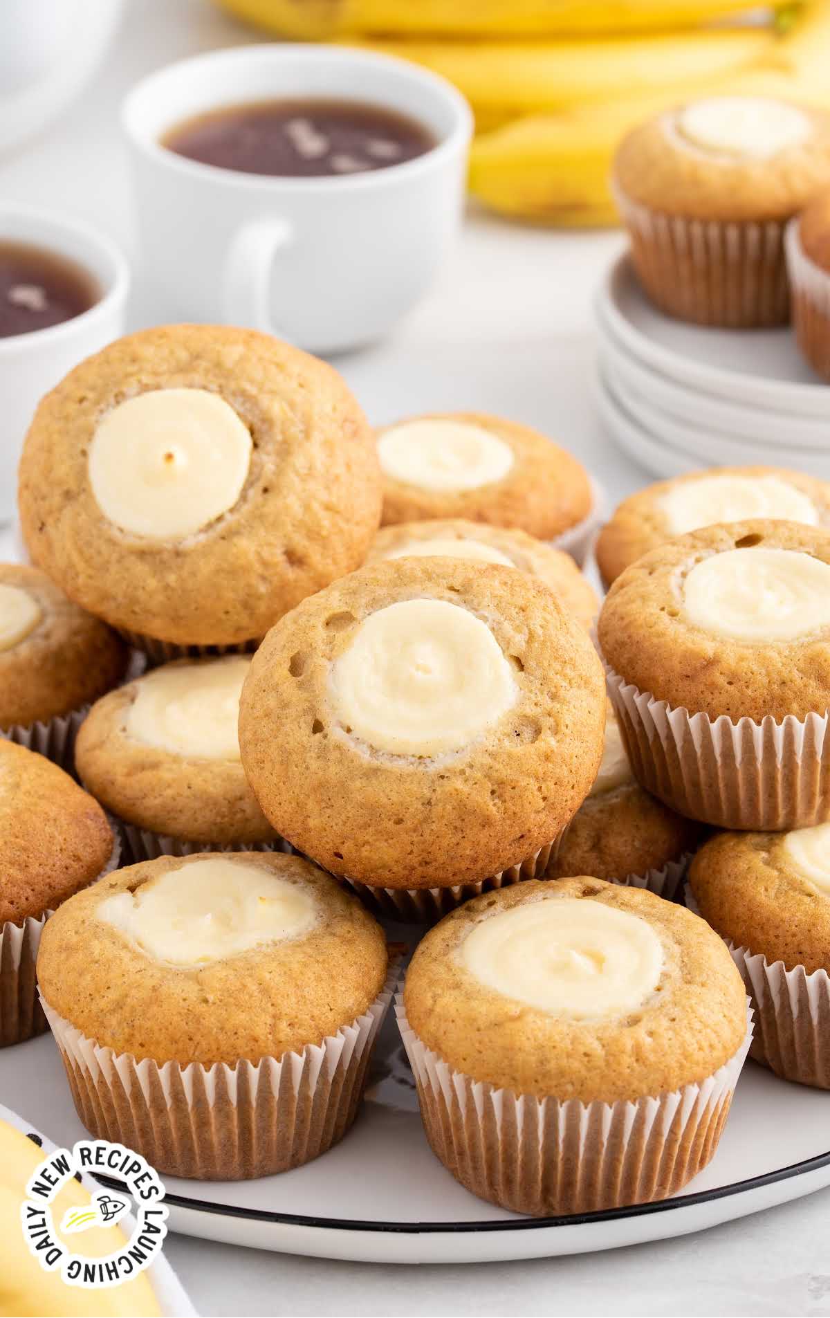 a bunch of Banana Cream Cheese Muffins on a plate