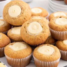 a close up shot of a bunch of Banana Cream Cheese Muffins