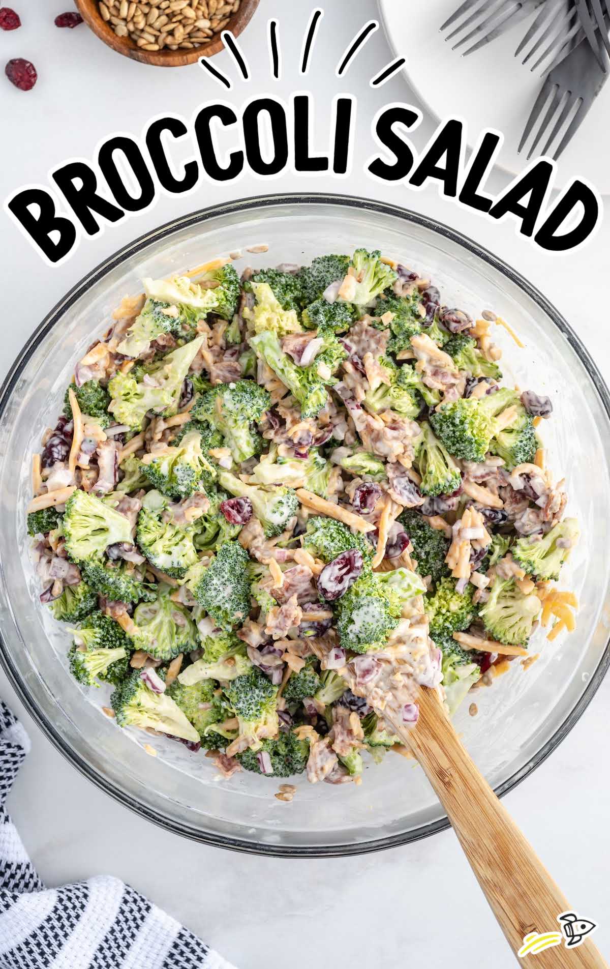 overhead shot of Broccoli Salad with wooden spoon