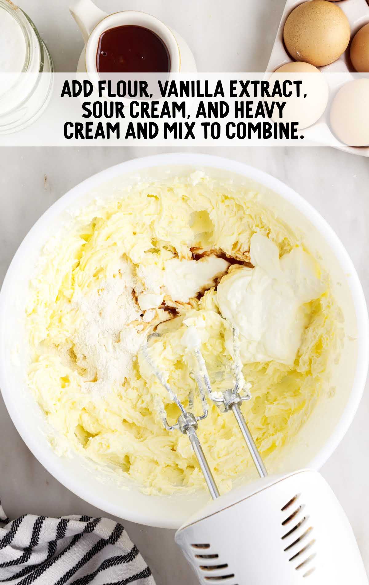 flour, vanilla extract, sour cream, and heavy cream blended in a bowl