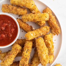 overhead shot of Cheese Sticks on a plate with marinara sauce