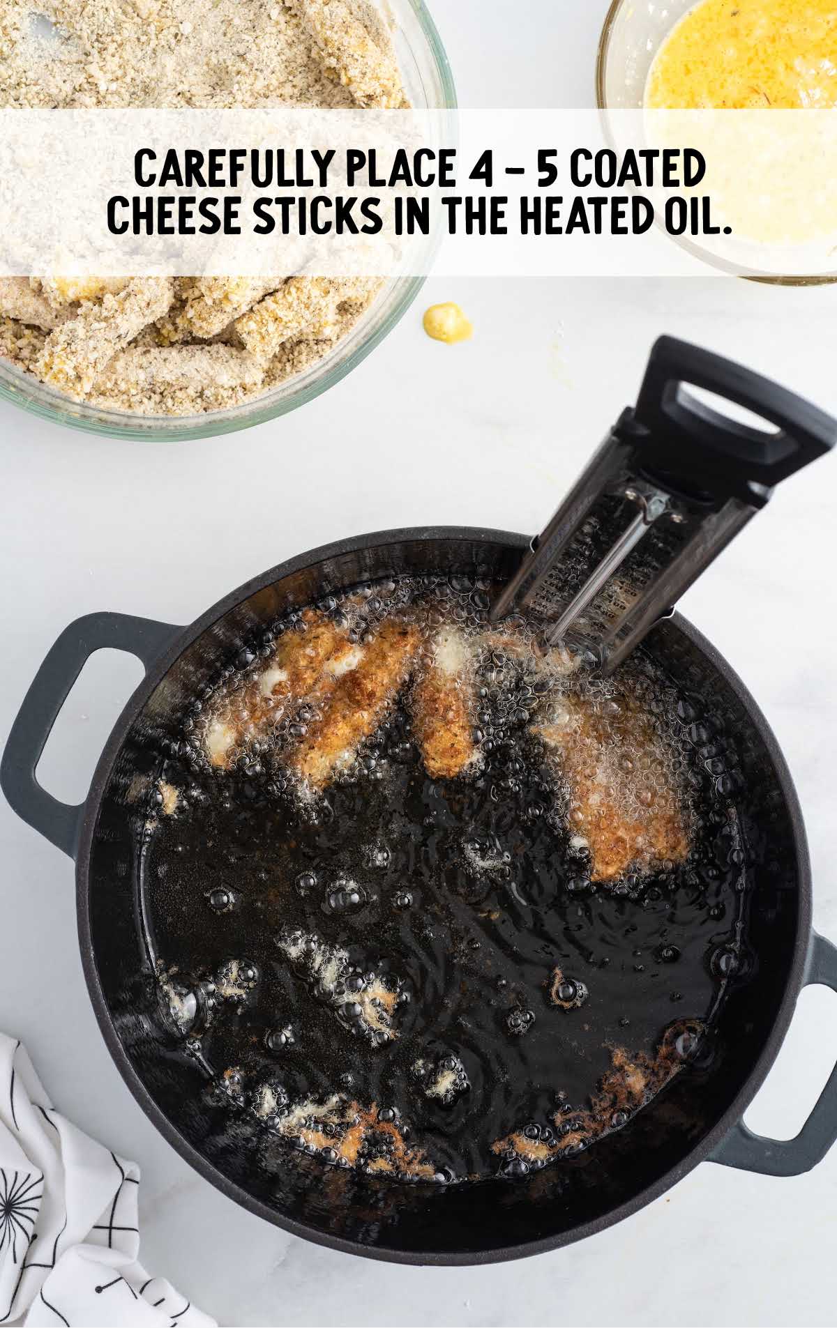 cheese sticks in a heated oil on a frying pan