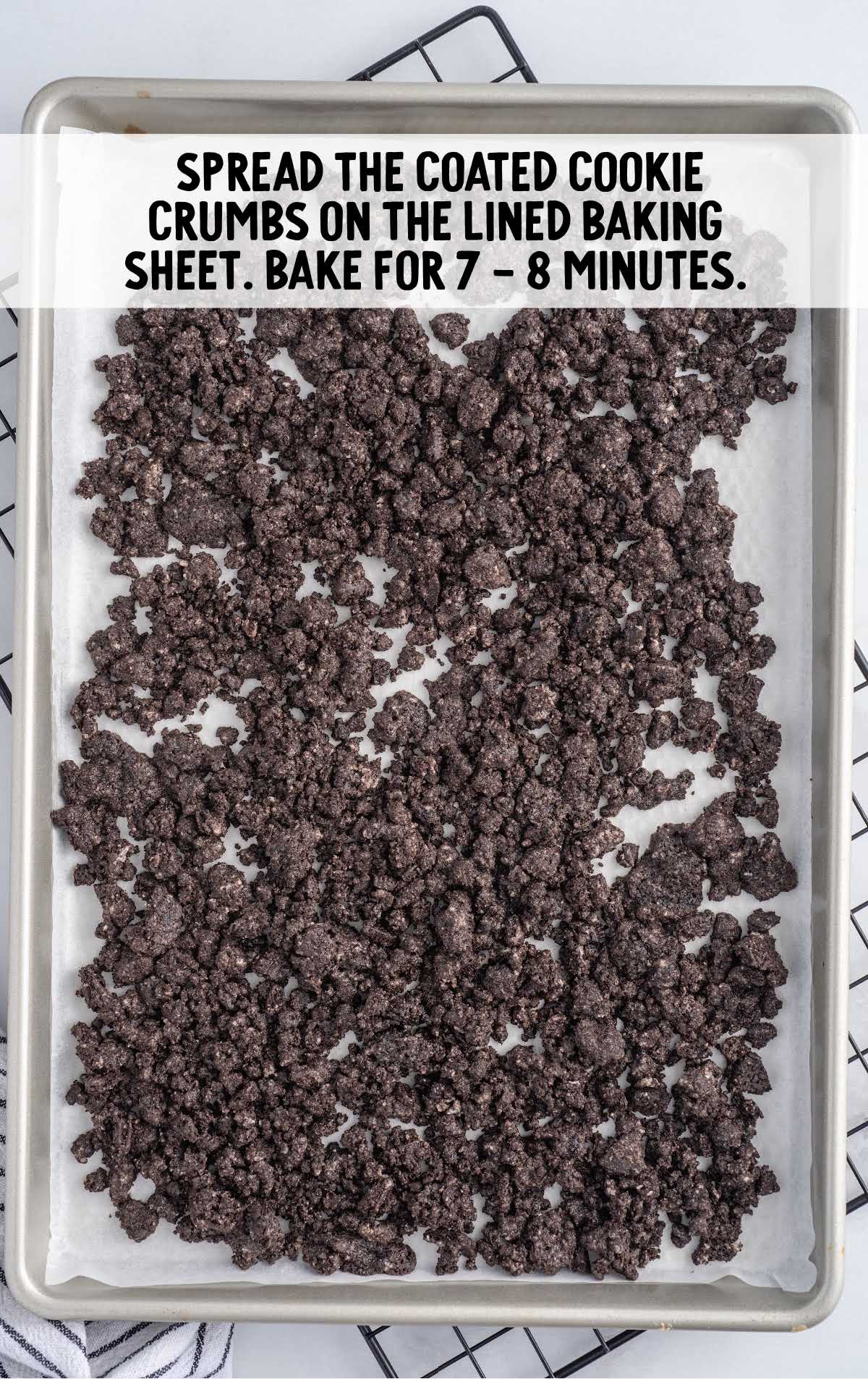 coated cookies crumbs spread on the lined baking sheet