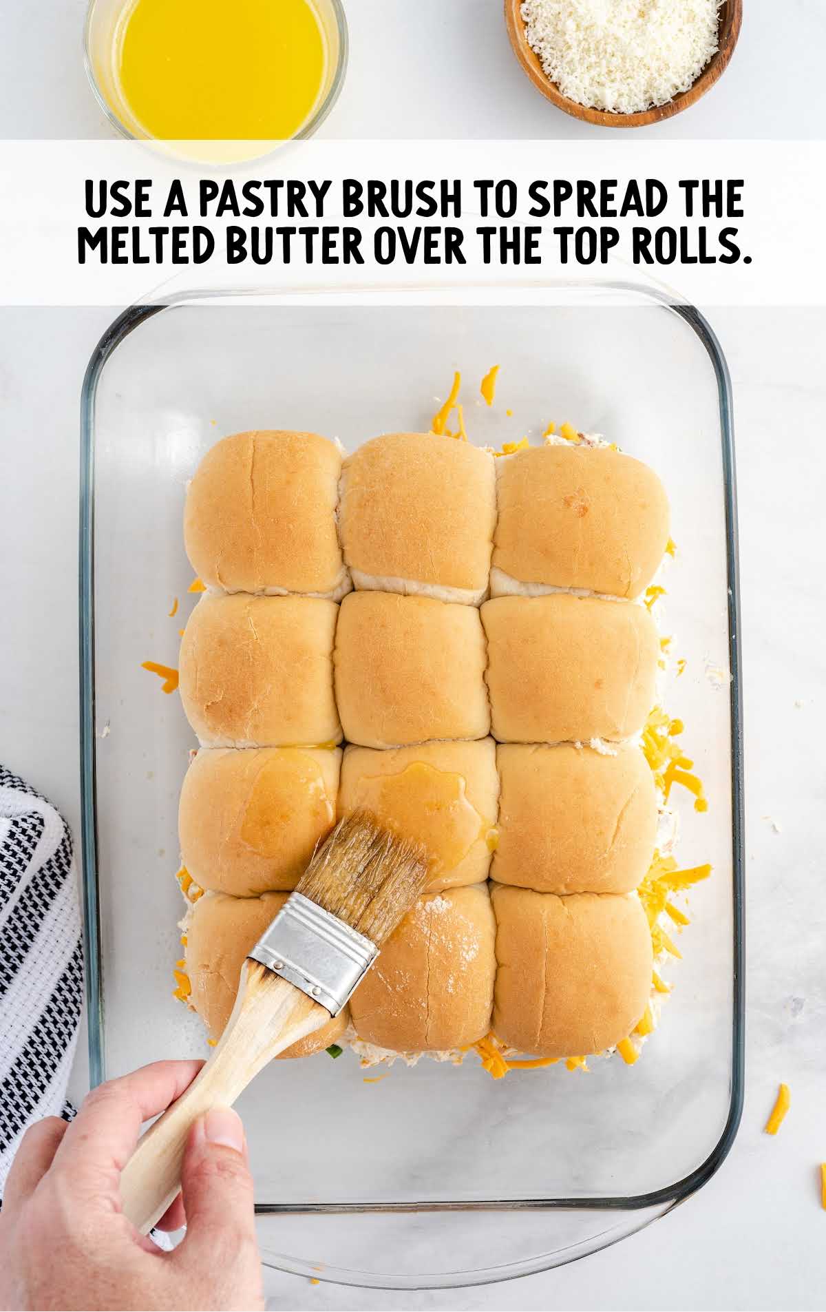 butter spread over the rolls using pastry bush in a baking dish