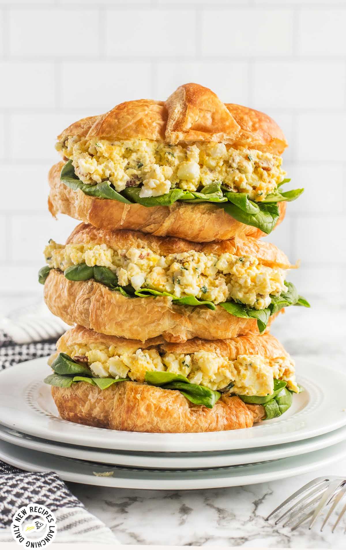 Egg Salad Sandwich stacked on top of each other on a plate
