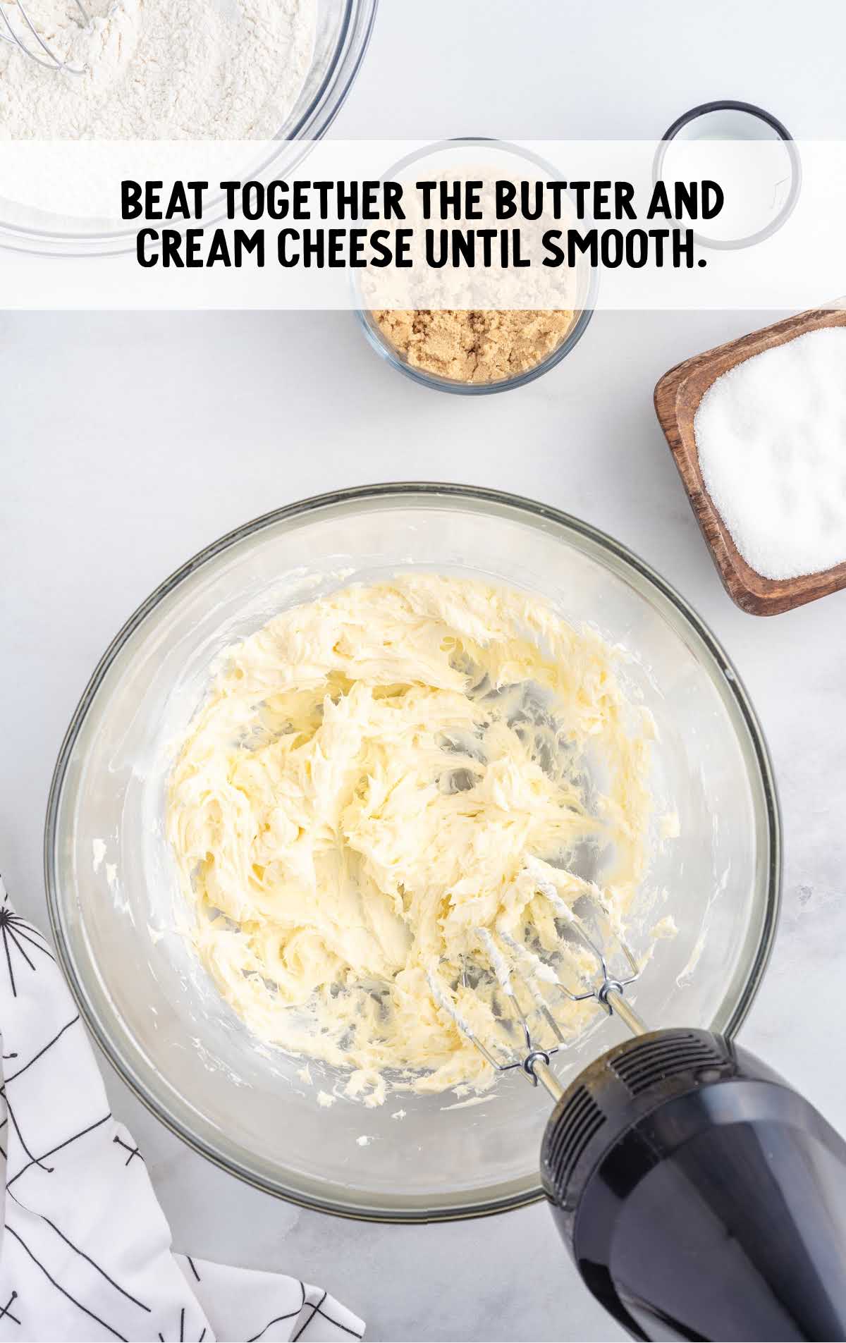 butter and cream cheese blended together in a bowl