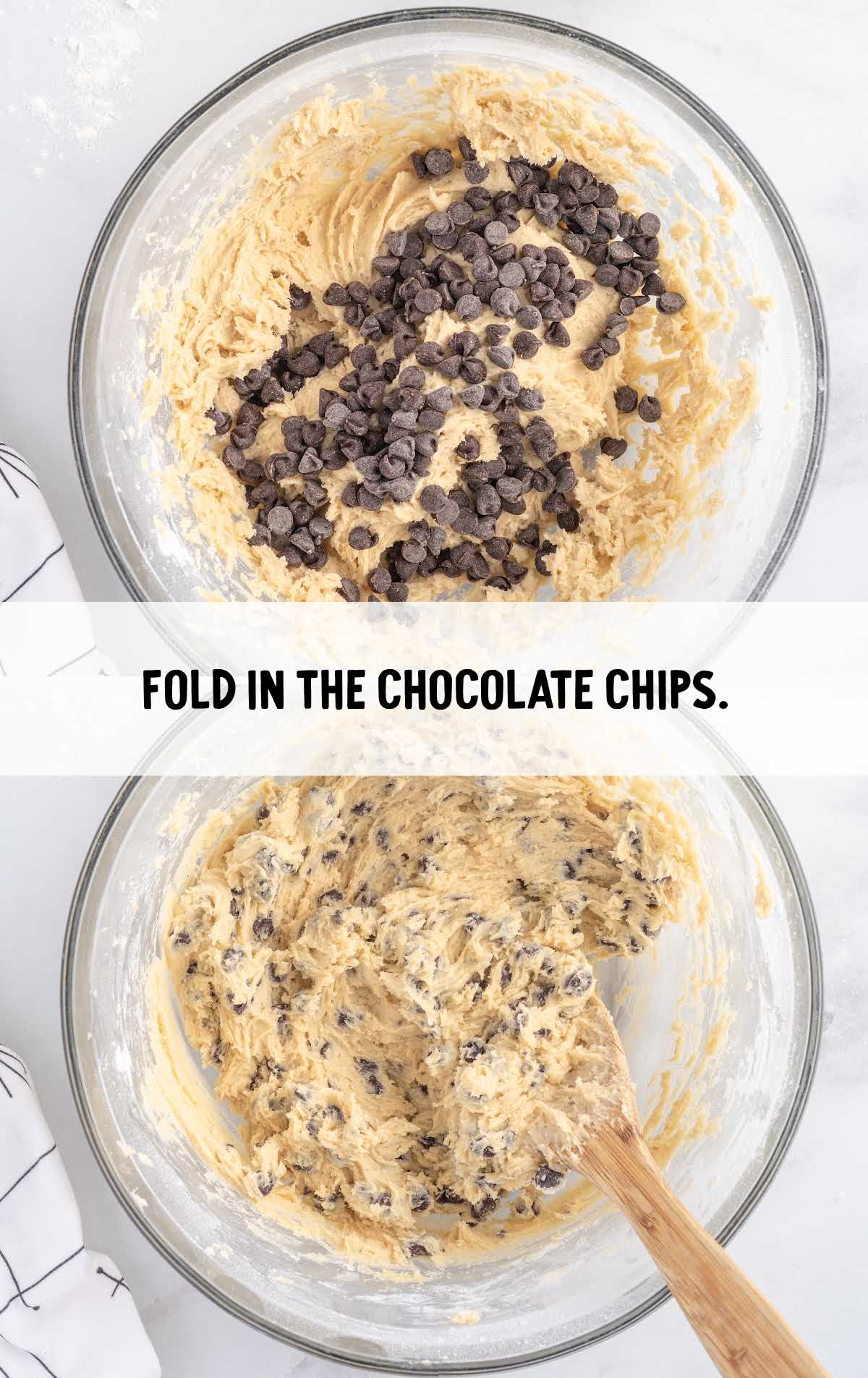 chocolate chips folded into the cookie dough batter in a bowl
