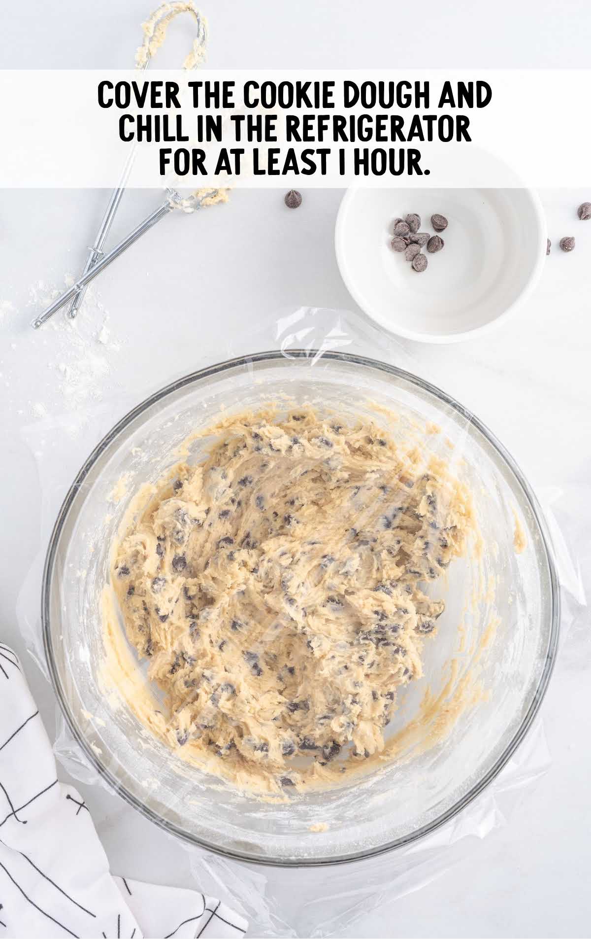 cookie dough covered in plastic wrap in a bowl bowl