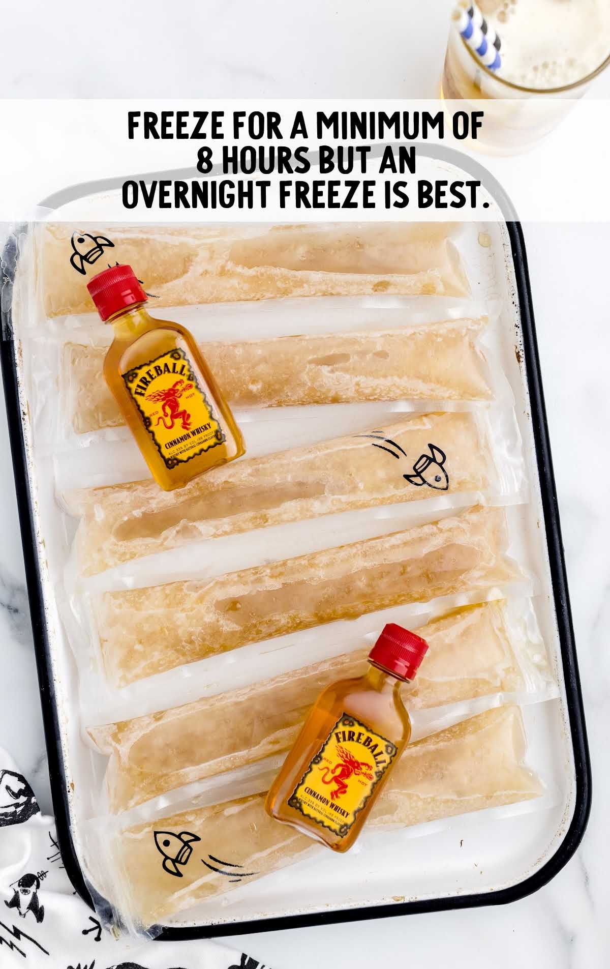 overhead shot of Fireball Whisky Popsicles and fireball bottle in a tray