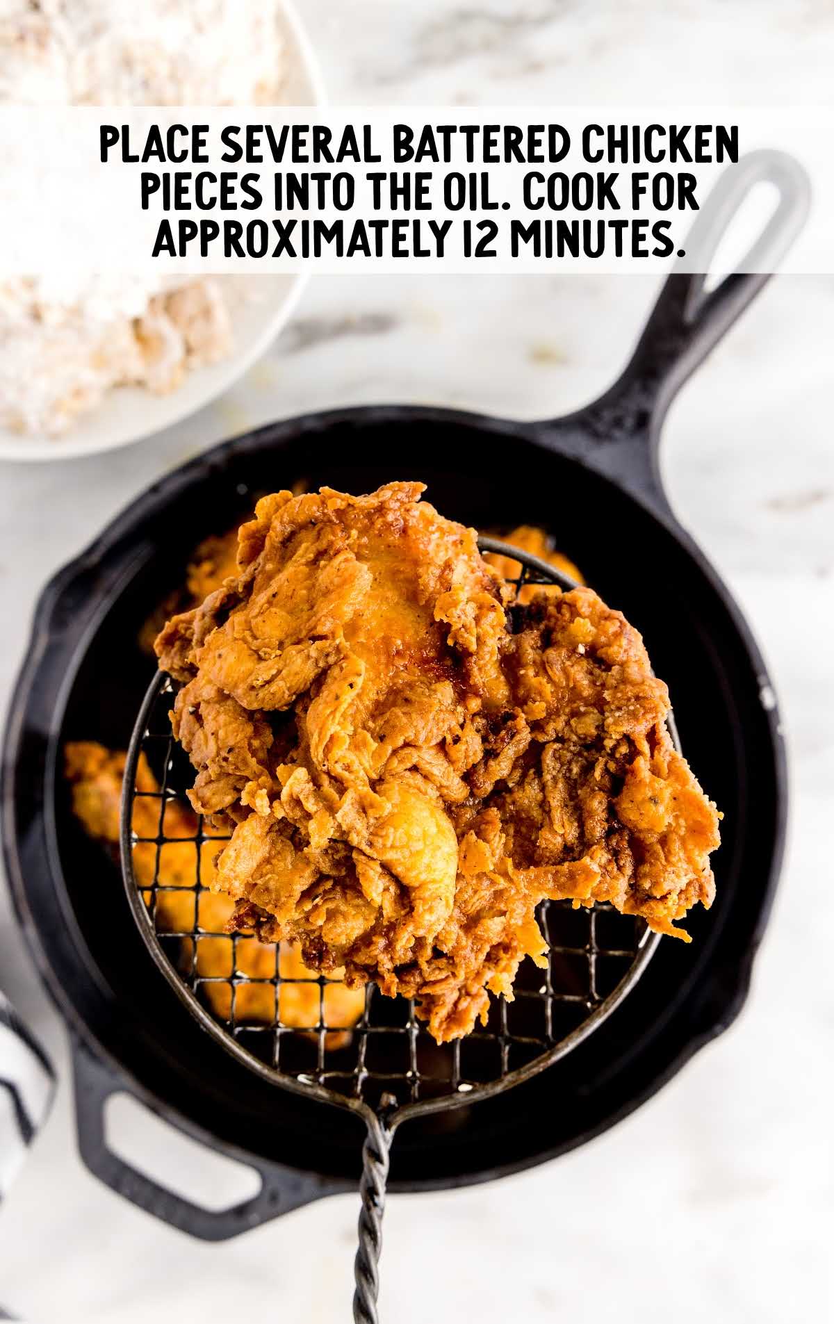 chicken placed in the oil in frying pan