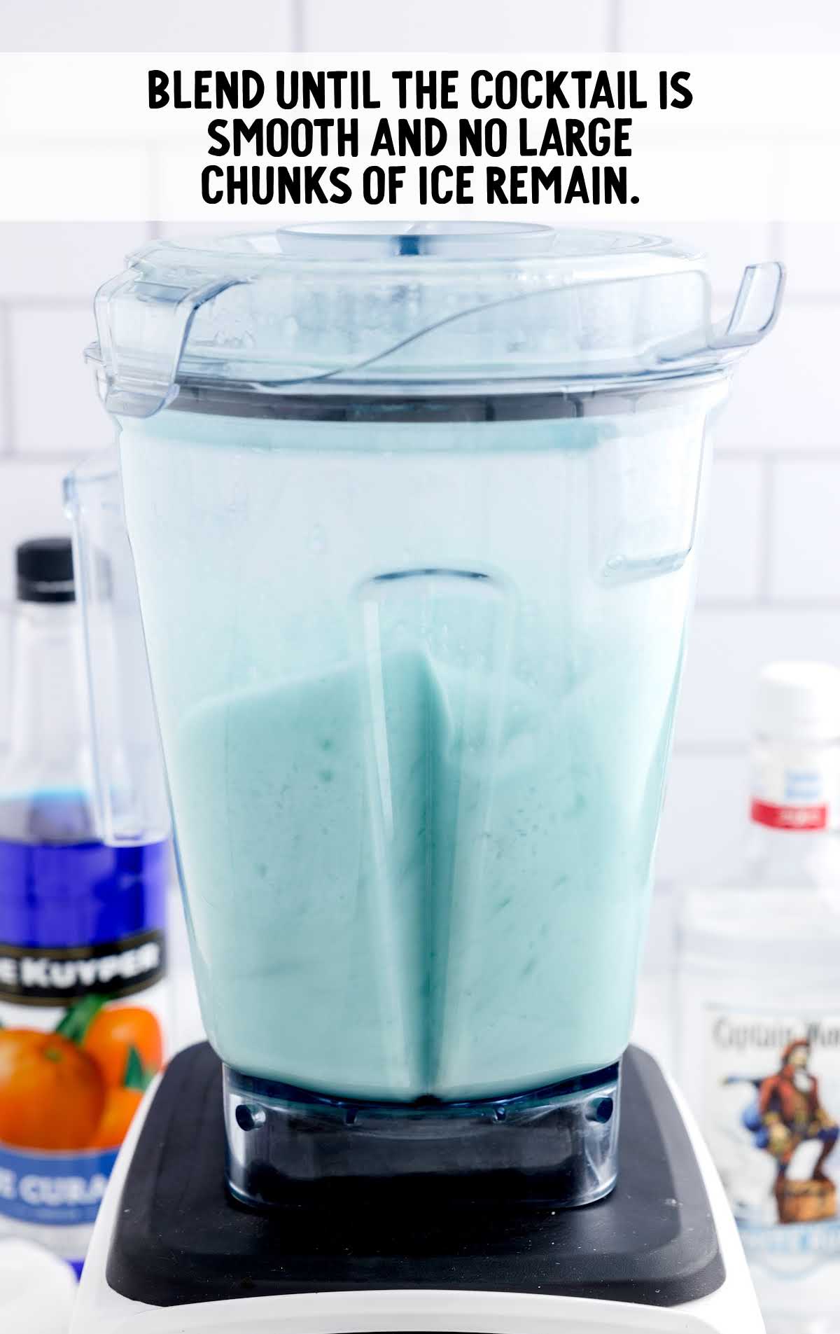 cocktail being blended with a blender