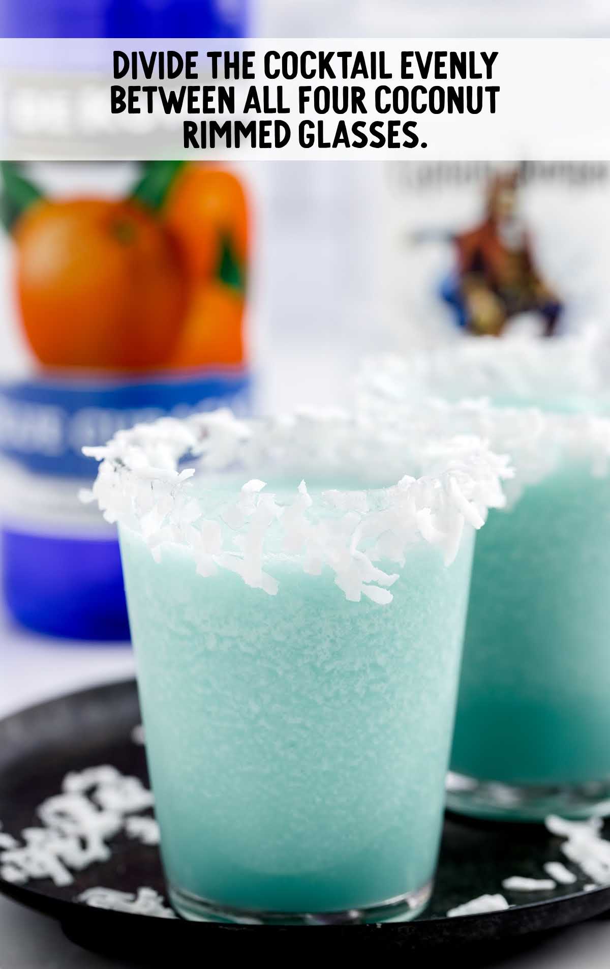 Jack Frost Cocktail poured in a glass with a coconut rim