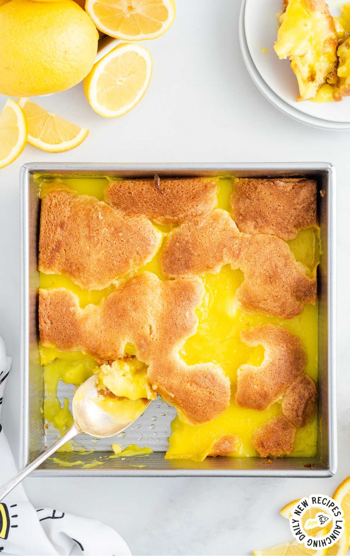 Lemon Cobbler in a baking dish with a spoon