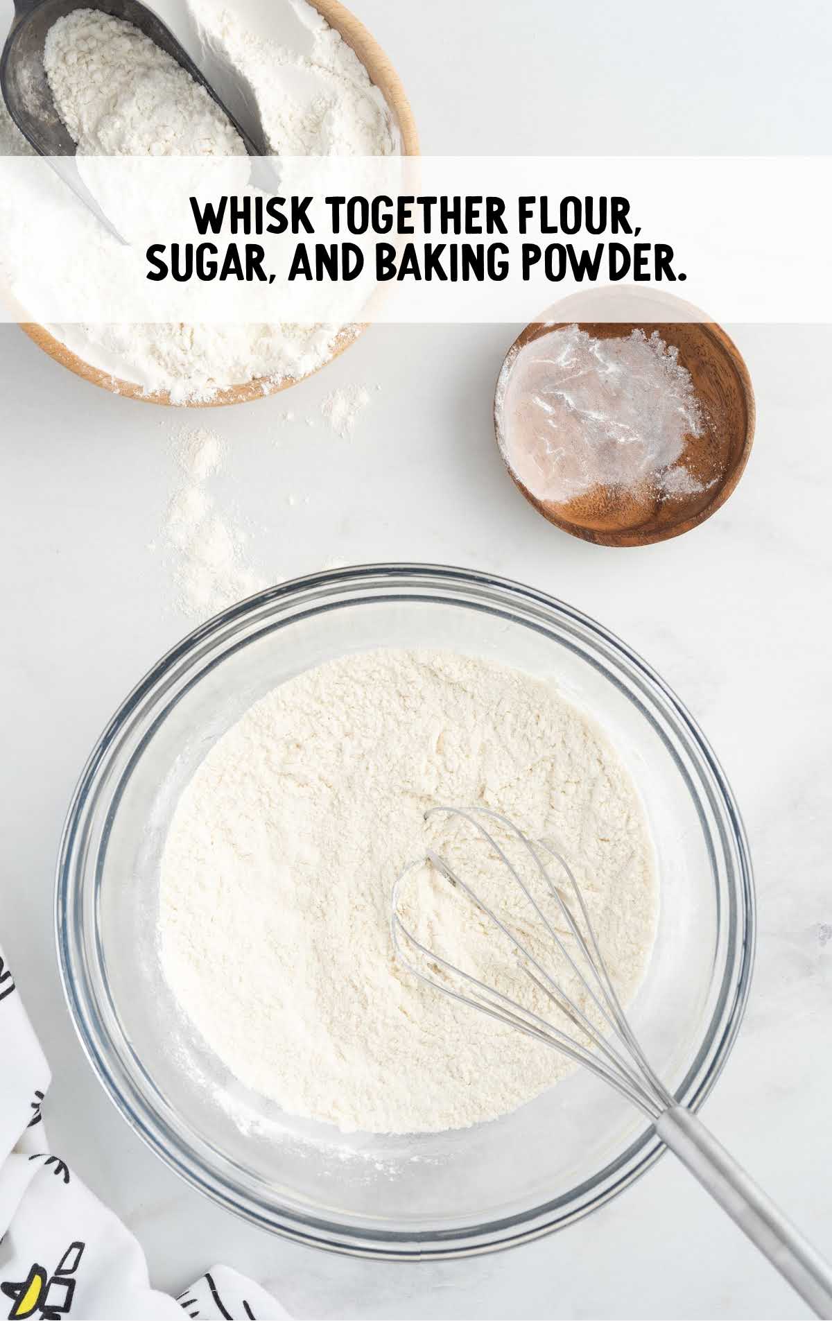 flour, sugar, and baking powder whisked together in a bowl
