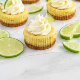 close up shot of Mini Key Lime Pies topped with a slice of lime