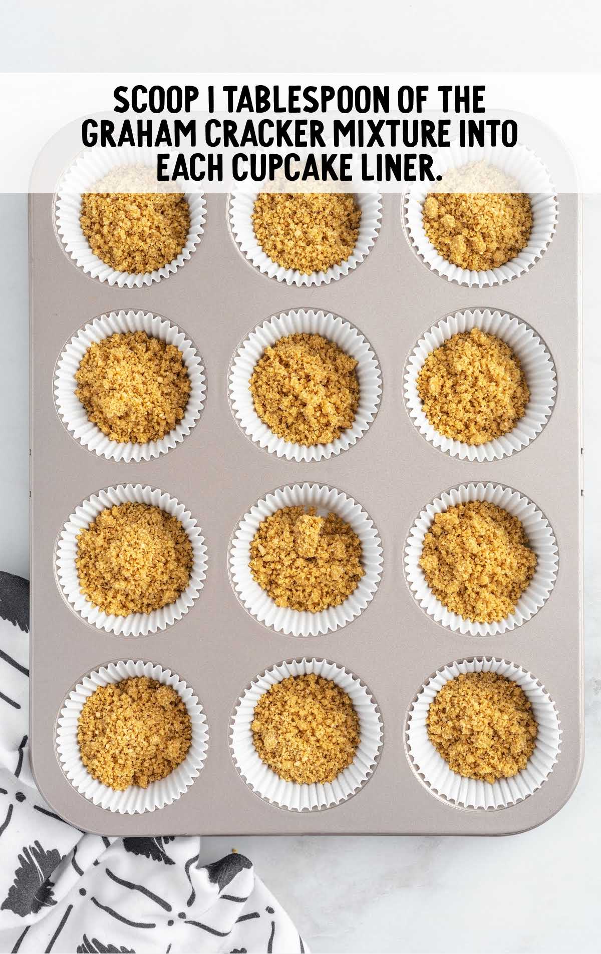 graham cracker mixture in a cupcake liner and in a cupcake pan