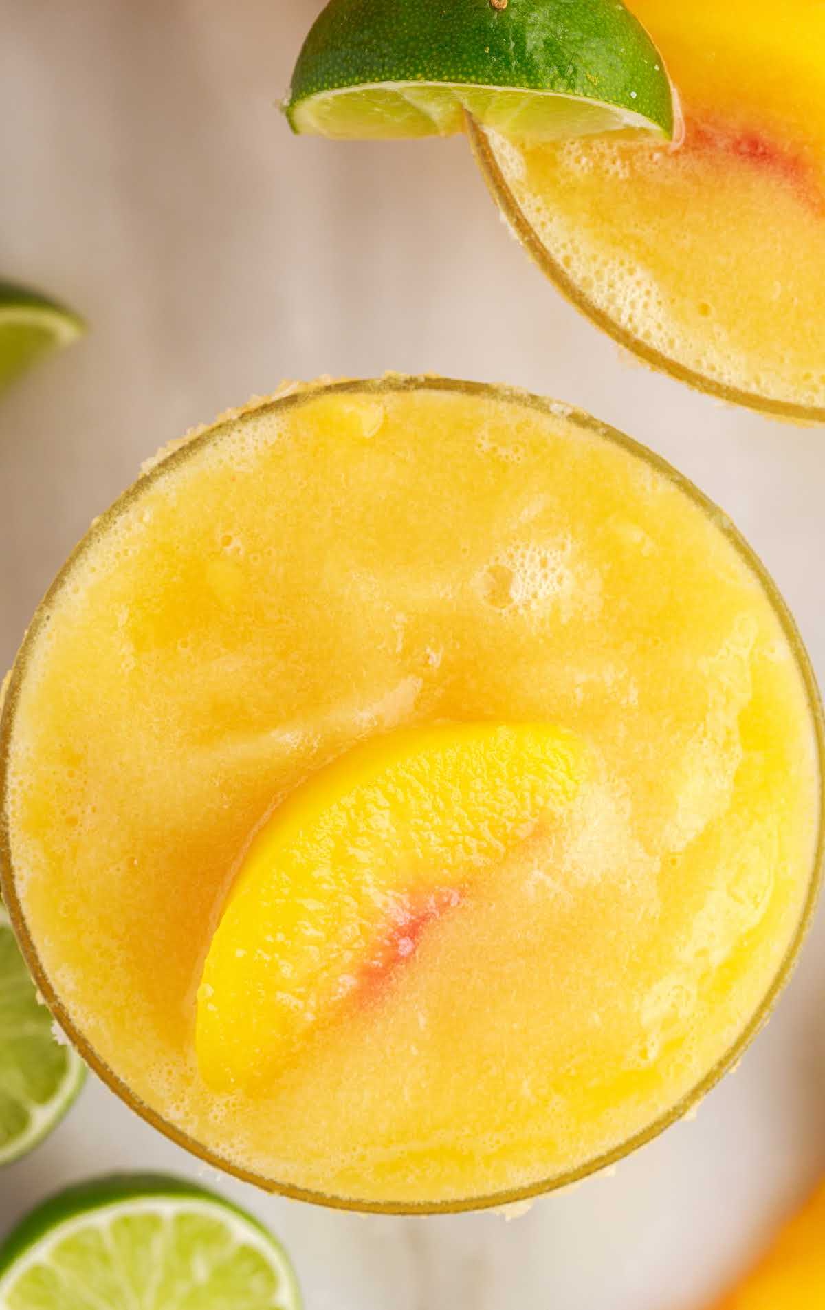 overhead shot of Peach Margaritas topped with a slice of peach