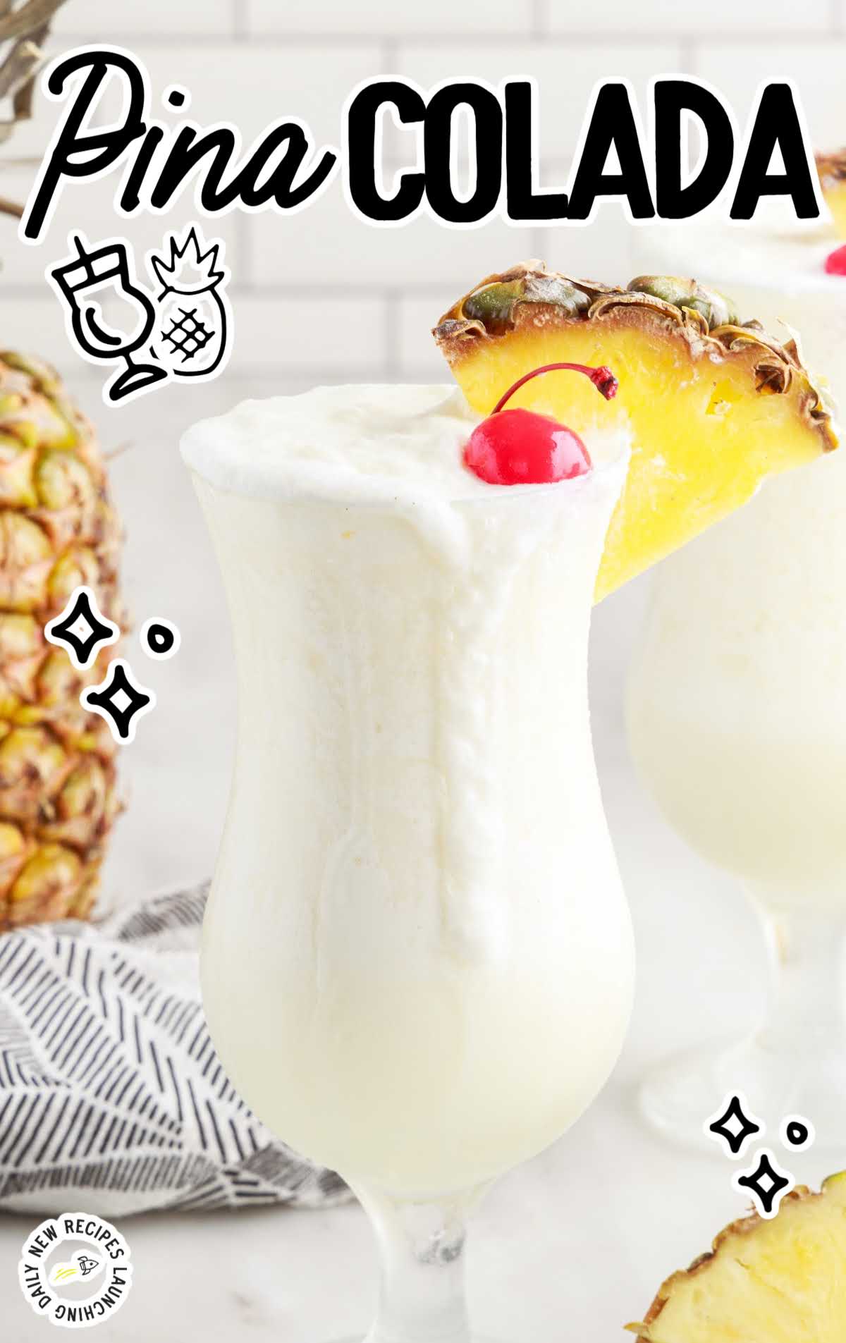 Pina Colada in a glass topped with a cherry and a slice of pineapple