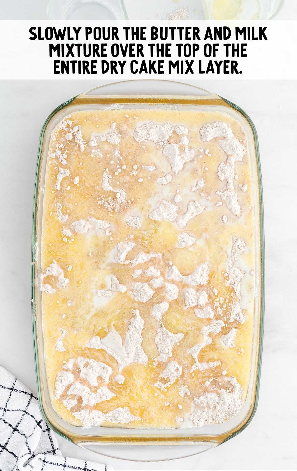 butter and milk mixtures poured on top of the dry cake
