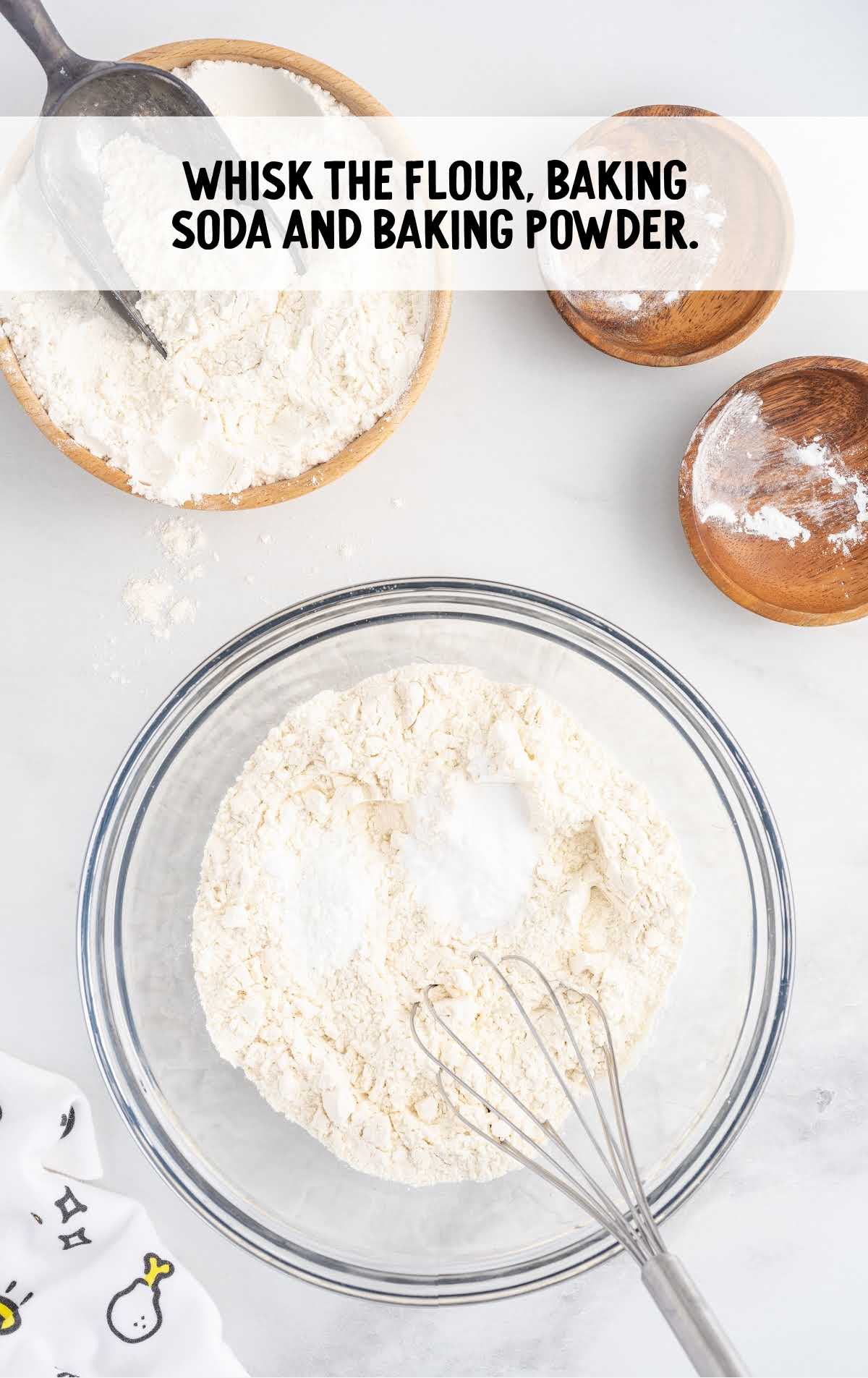 flour, baking soda, and baking powder whisked together in a bowl
