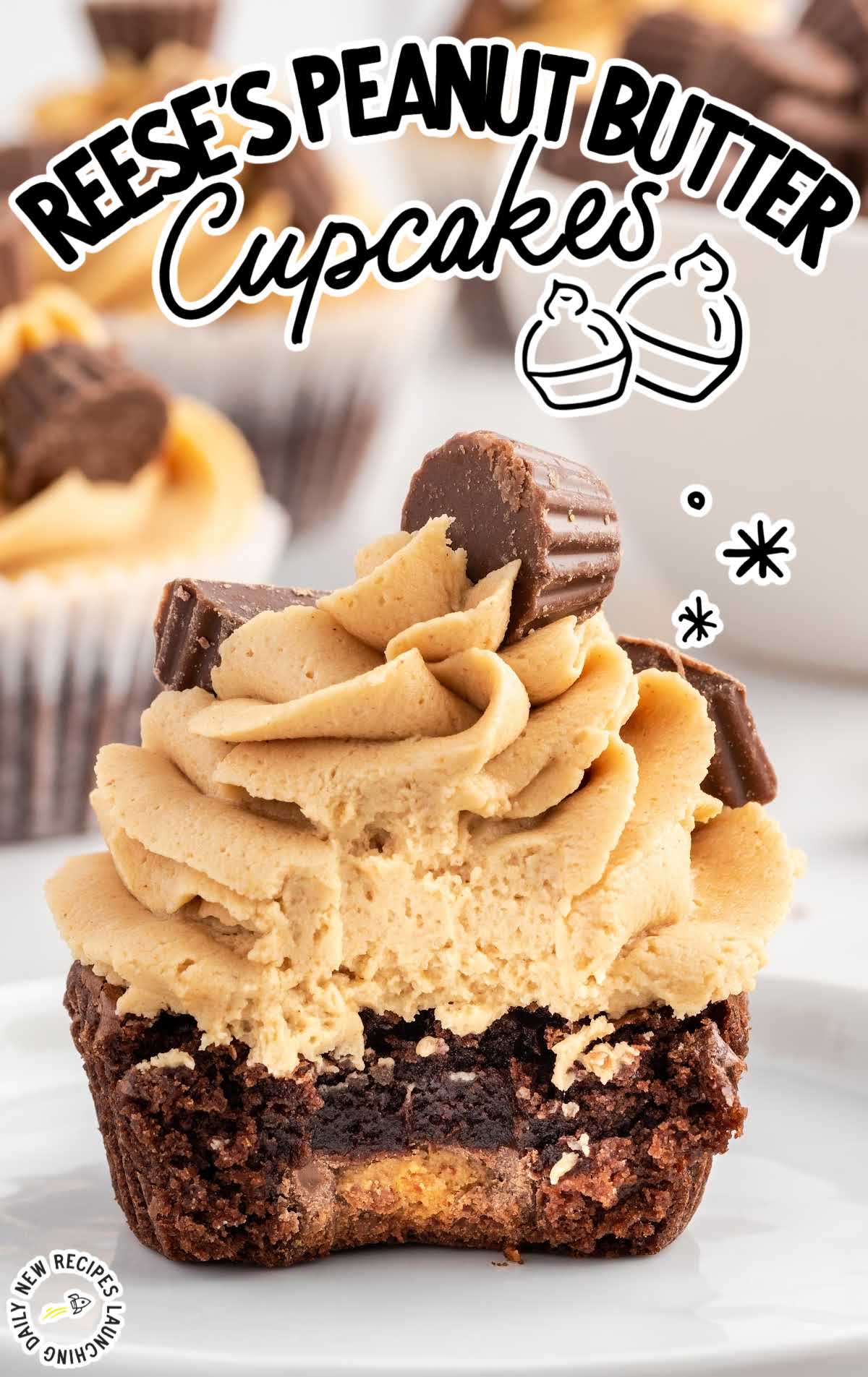 a close up shot of Reese's Peanut Butter Cupcake with a bite taken out of it on a plate