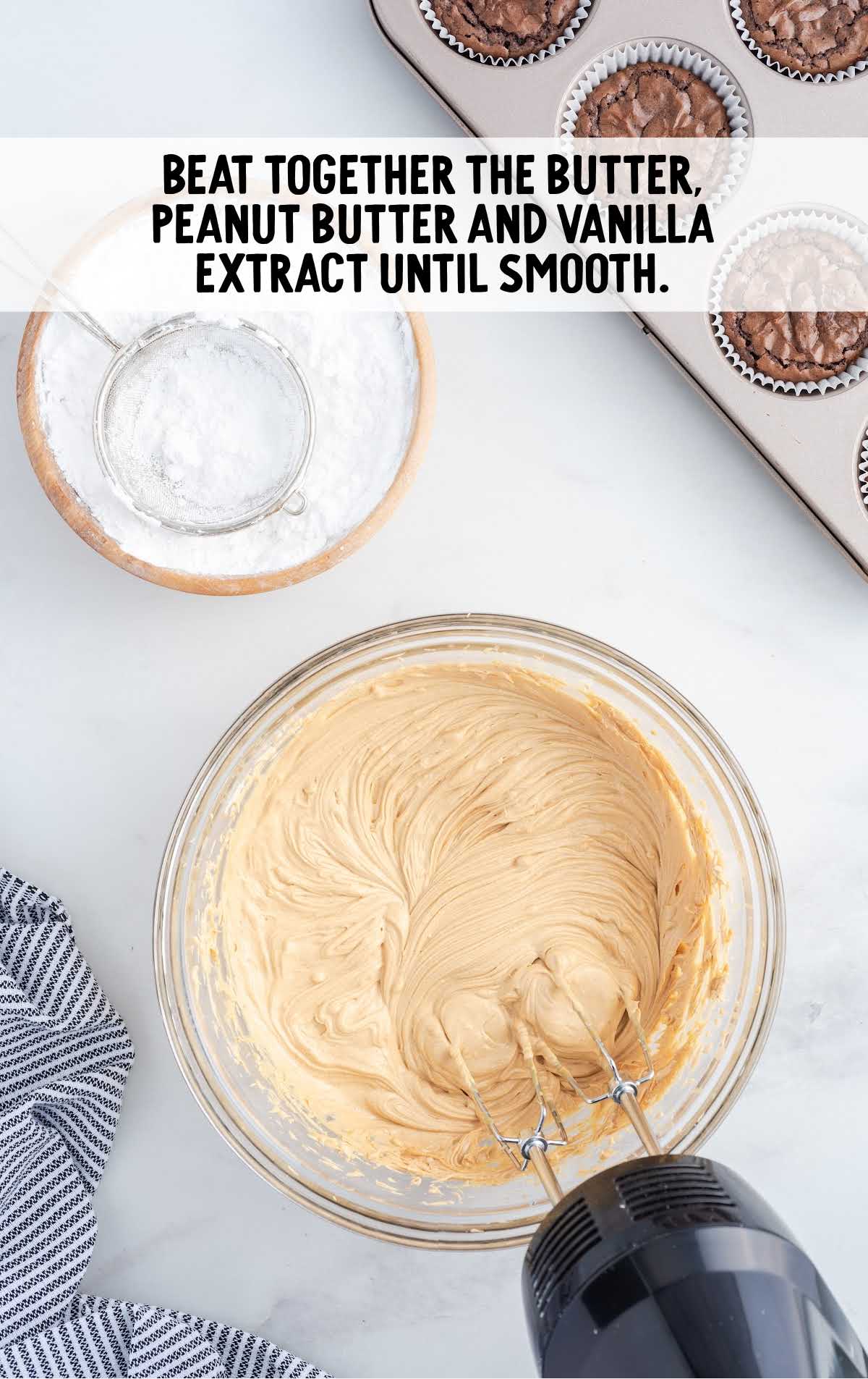 butter, peanut butter, and vanilla blended together in a bowl