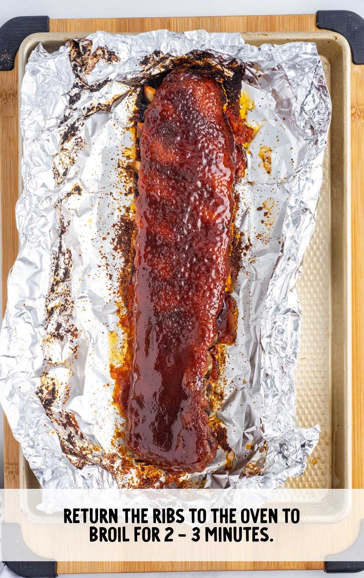 cooked rib on foil and on a baking tray