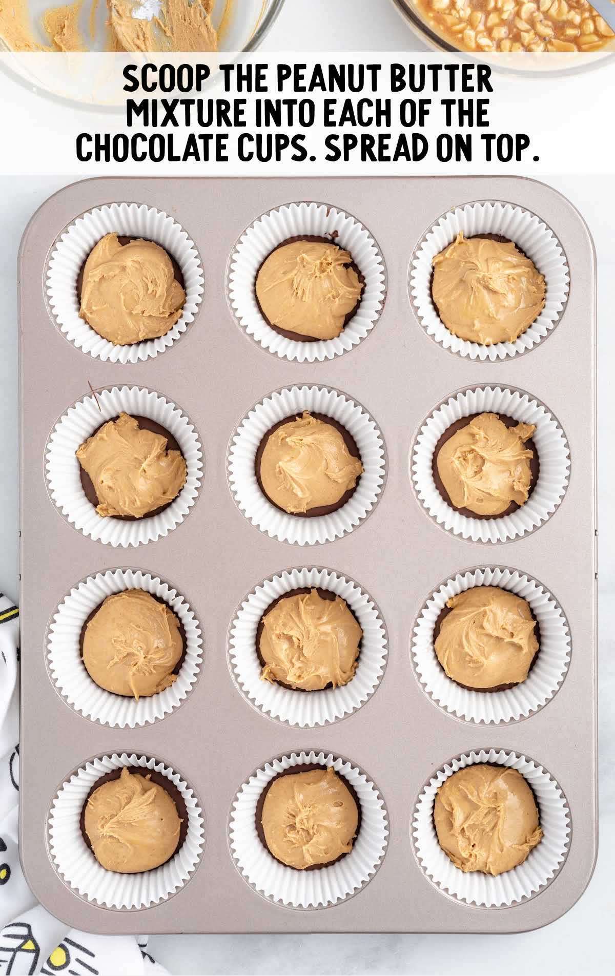 peanut butter mixture scooped into each of the chocolate cups in a cupcake pan 