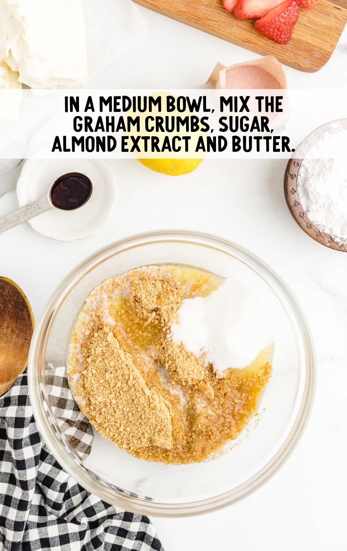 graham crumbs, sugar, almond extract and butter mixed in a bowl