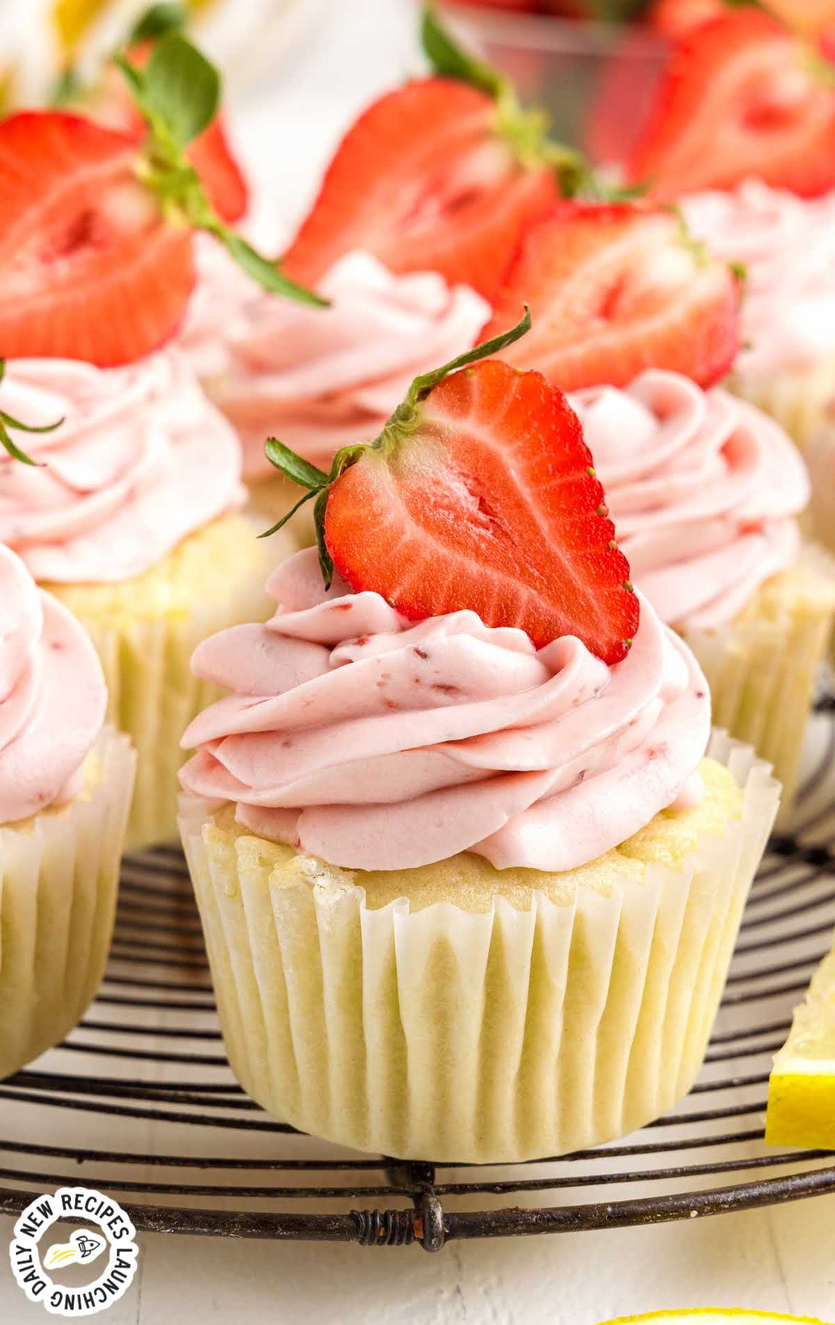 Strawberry Lemon Cupcakes topped with strawberries on a stand
