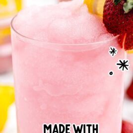 Strawberry Lemonade Cocktail in a glass with a slice of lemon and strawberry in a glass