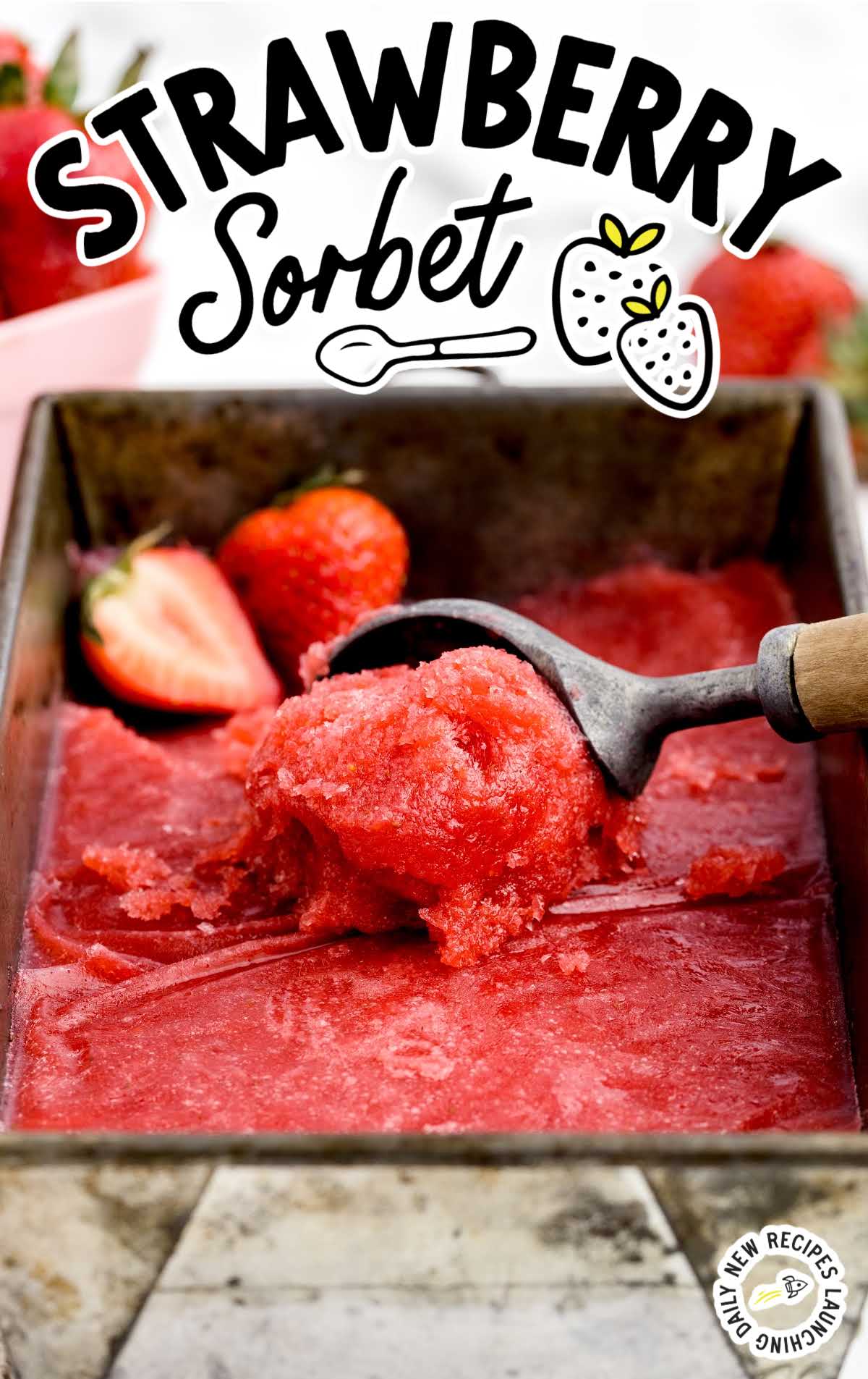 Strawberry Sorbet being scooped out of a pan with an ice cream scooper