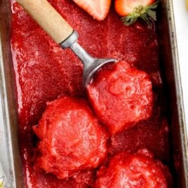 overhead shot of Strawberry Sorbet being scooped out of a pan with an ice cream scooper