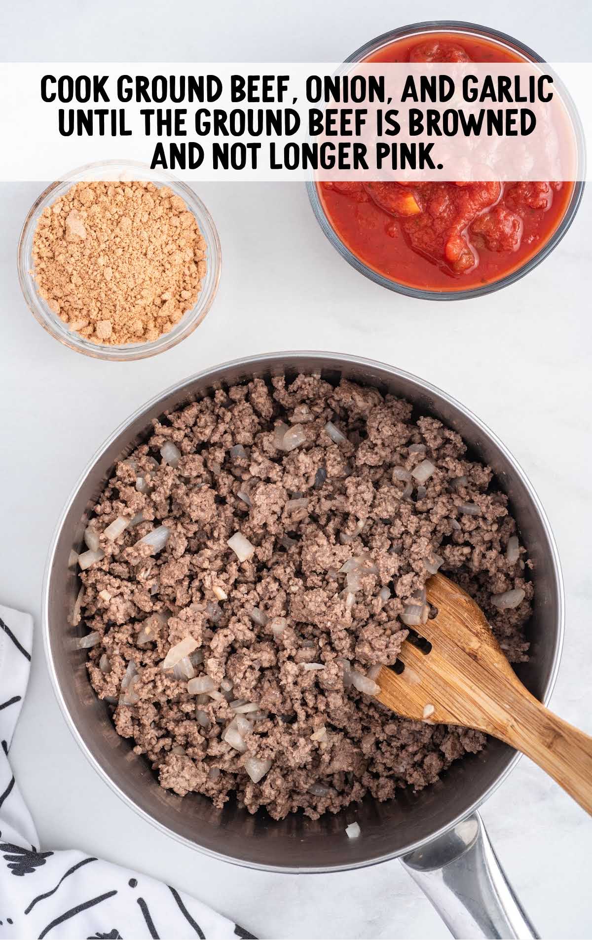 beef, onion, and garlic folded together in a pan
